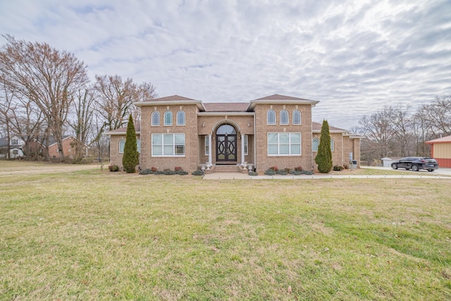 view of front facade featuring brick siding and a front lawn