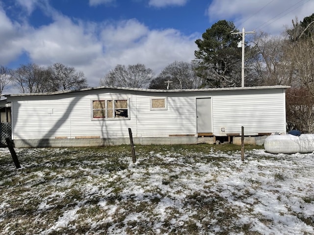 snow covered property featuring entry steps and fence