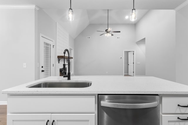 kitchen featuring white cabinetry, light stone counters, stainless steel dishwasher, and decorative light fixtures