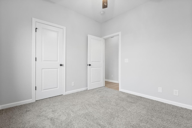 unfurnished bedroom featuring ceiling fan, carpet flooring, and baseboards