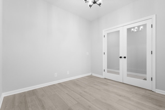 unfurnished room featuring light wood-type flooring, baseboards, and french doors