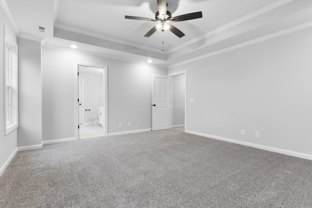 unfurnished bedroom with visible vents, baseboards, ornamental molding, carpet, and a tray ceiling