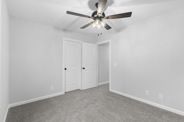 unfurnished bedroom with carpet floors, ceiling fan, and baseboards