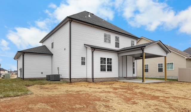 back of property with ceiling fan, roof with shingles, a patio, and central air condition unit