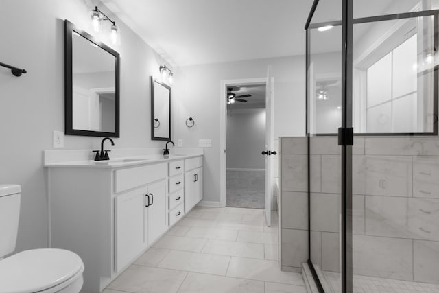 bathroom with ceiling fan, a sink, toilet, and double vanity