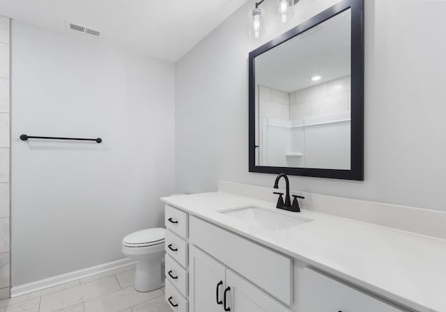 bathroom with baseboards, visible vents, toilet, walk in shower, and vanity