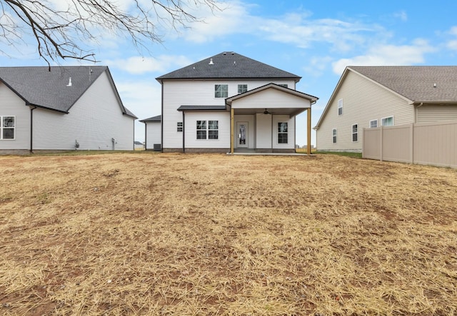 rear view of house with a yard, a patio area, fence, and a ceiling fan