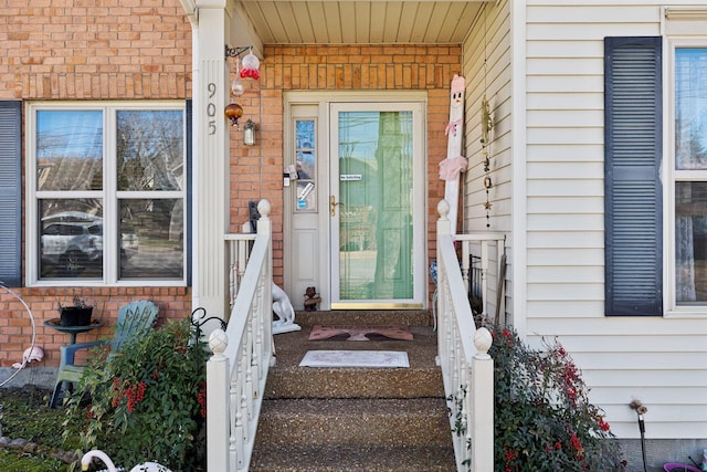 view of exterior entry with brick siding