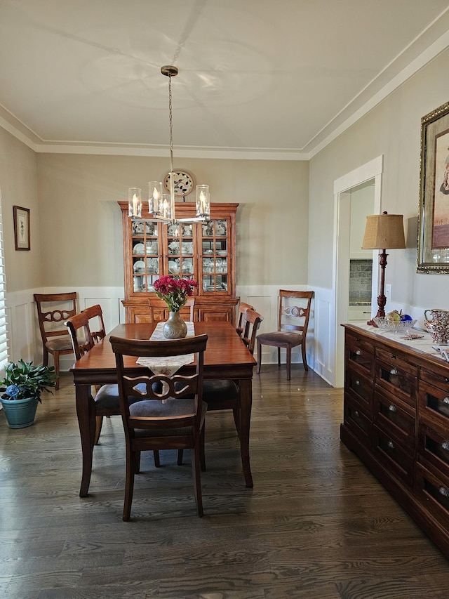 dining room featuring an inviting chandelier, dark wood-style flooring, and wainscoting