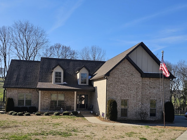 view of front facade with board and batten siding and brick siding