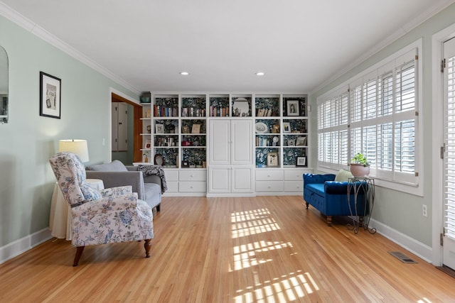 living area with crown molding, light wood finished floors, recessed lighting, visible vents, and baseboards