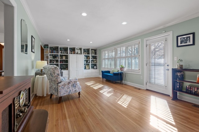 living area featuring light wood finished floors, recessed lighting, visible vents, and crown molding