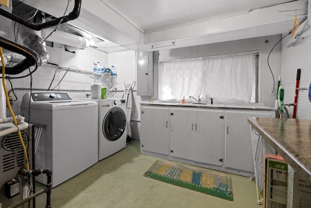 laundry area featuring electric panel, cabinet space, independent washer and dryer, and a sink