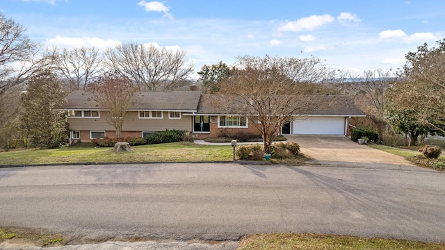 view of front of property with driveway, an attached garage, and a front yard