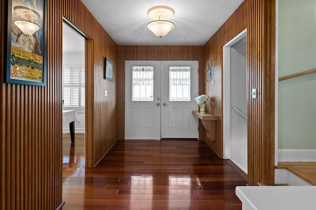 foyer with baseboards, dark wood finished floors, and french doors