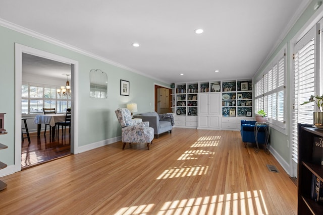 unfurnished room featuring ornamental molding, baseboards, an inviting chandelier, and wood finished floors