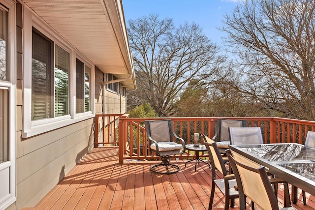 wooden terrace with outdoor dining space