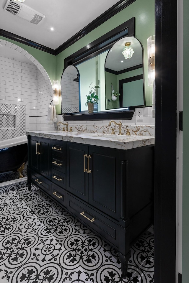 full bathroom with ornamental molding, a sink, backsplash, and double vanity