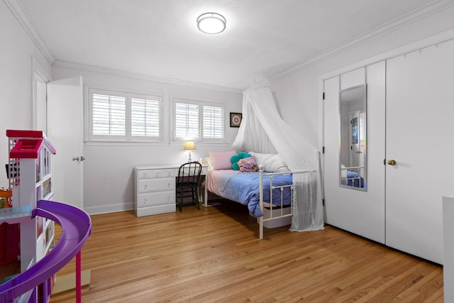 bedroom with ornamental molding and light wood-style floors