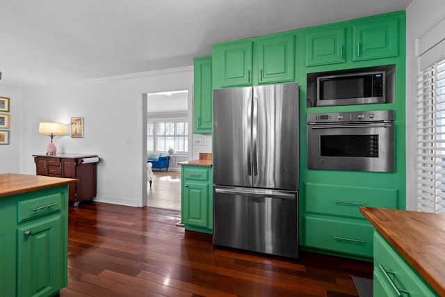 kitchen featuring green cabinets, wooden counters, appliances with stainless steel finishes, and dark wood-style floors