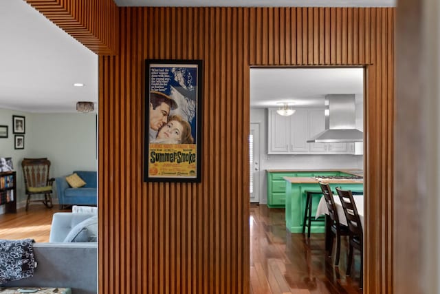 interior space featuring ornamental molding, wood finished floors, and baseboards