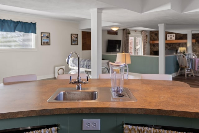 kitchen with decorative columns and baseboards