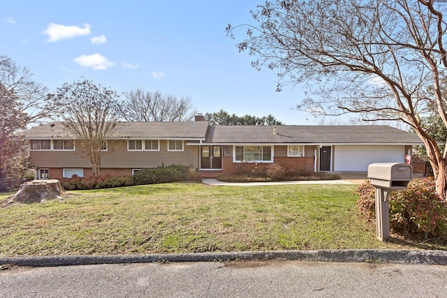 view of front facade featuring a garage, brick siding, a chimney, and a front yard