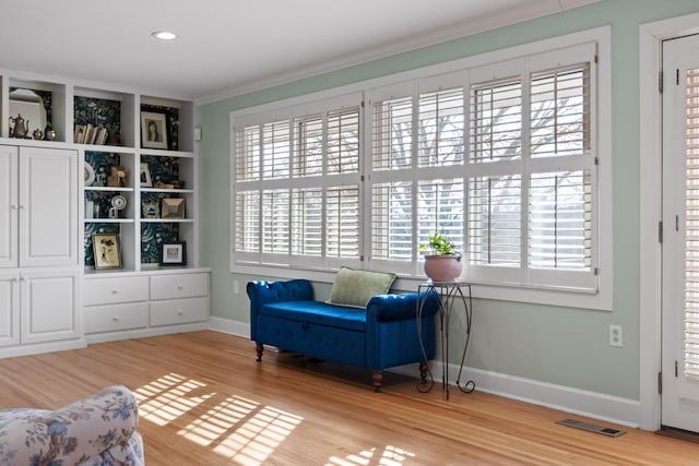 sitting room featuring baseboards, visible vents, light wood-style flooring, crown molding, and recessed lighting