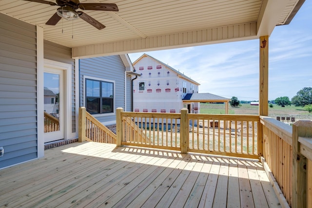 wooden terrace featuring ceiling fan