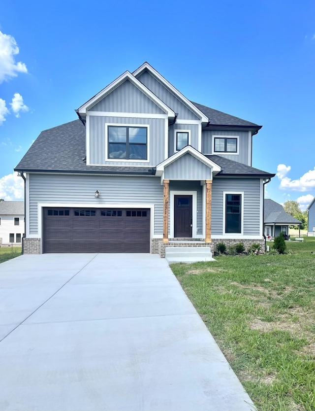 view of front facade featuring a front yard, concrete driveway, brick siding, and roof with shingles