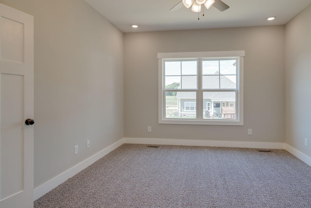 carpeted spare room featuring ceiling fan, recessed lighting, visible vents, and baseboards