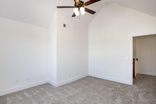 empty room with lofted ceiling, light carpet, baseboards, and a ceiling fan