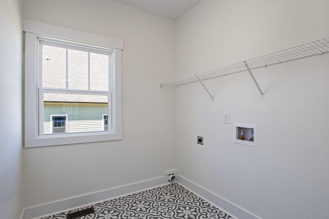 laundry room featuring laundry area, baseboards, tile patterned floors, washer hookup, and electric dryer hookup