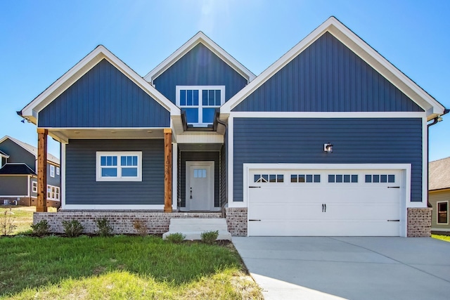 view of front facade featuring board and batten siding, brick siding, driveway, and a garage