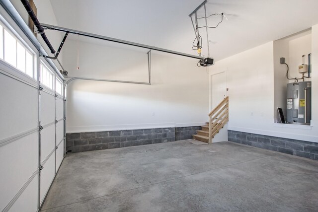 garage featuring concrete block wall and electric water heater