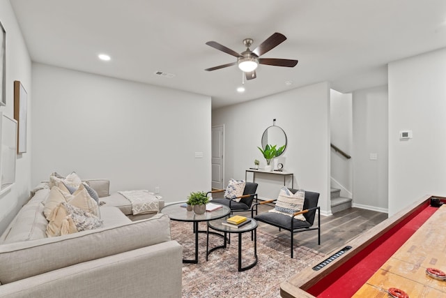 living area featuring visible vents, ceiling fan, stairway, wood finished floors, and recessed lighting