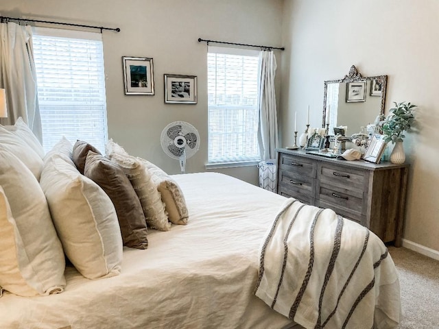 carpeted bedroom featuring baseboards