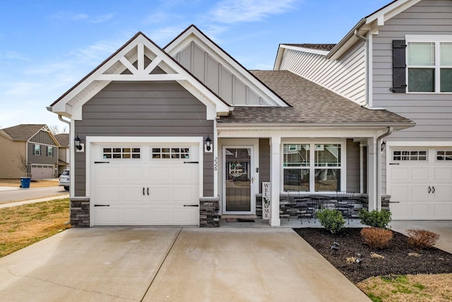 view of front of property with a garage, covered porch, concrete driveway, roof with shingles, and board and batten siding