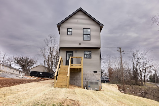 view of front of property with stairs and cooling unit