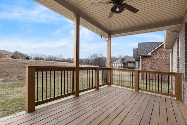 deck featuring a residential view and a ceiling fan