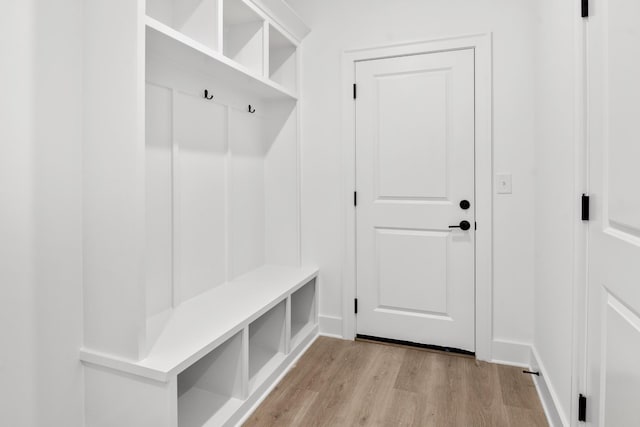 mudroom with light wood-style floors and baseboards