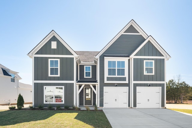 view of front of house with driveway, a garage, a front lawn, and board and batten siding