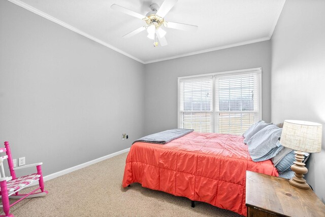 carpeted bedroom featuring ceiling fan, ornamental molding, and baseboards