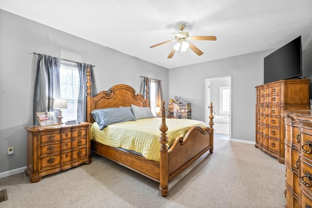 bedroom with a ceiling fan, light carpet, visible vents, and baseboards