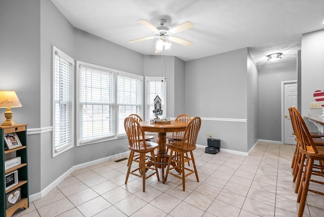 dining space featuring light tile patterned floors and baseboards