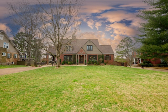 view of front of home with brick siding and a front yard