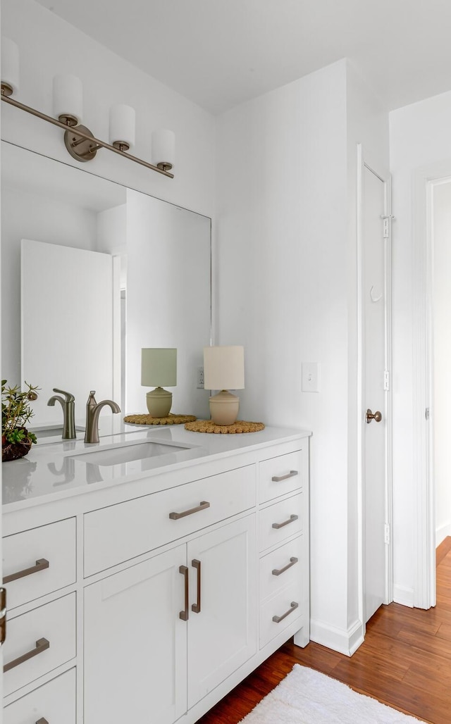 bathroom featuring wood finished floors and vanity