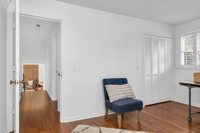 sitting room with baseboards and wood finished floors