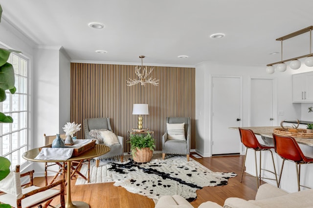 sitting room featuring ornamental molding and dark wood-style flooring