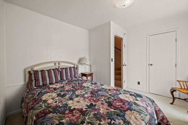 carpeted bedroom with a textured ceiling